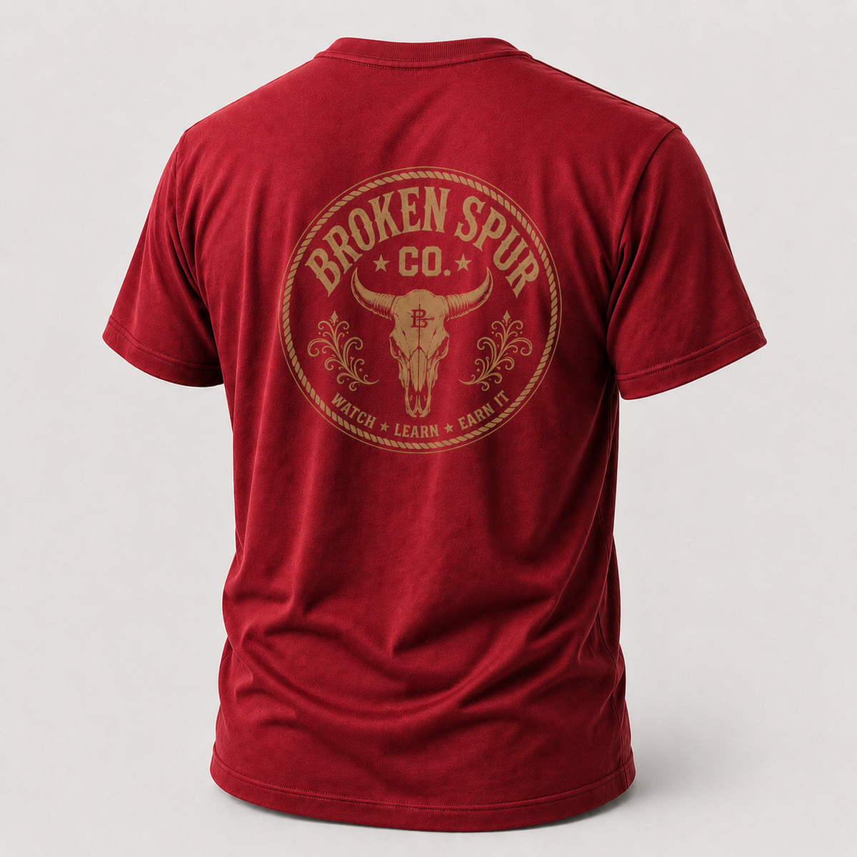 Antique Cherry Red Earn It Western Skull T-shirt, back view featuring a weathered Western skull badge and Watch Learn Earn It