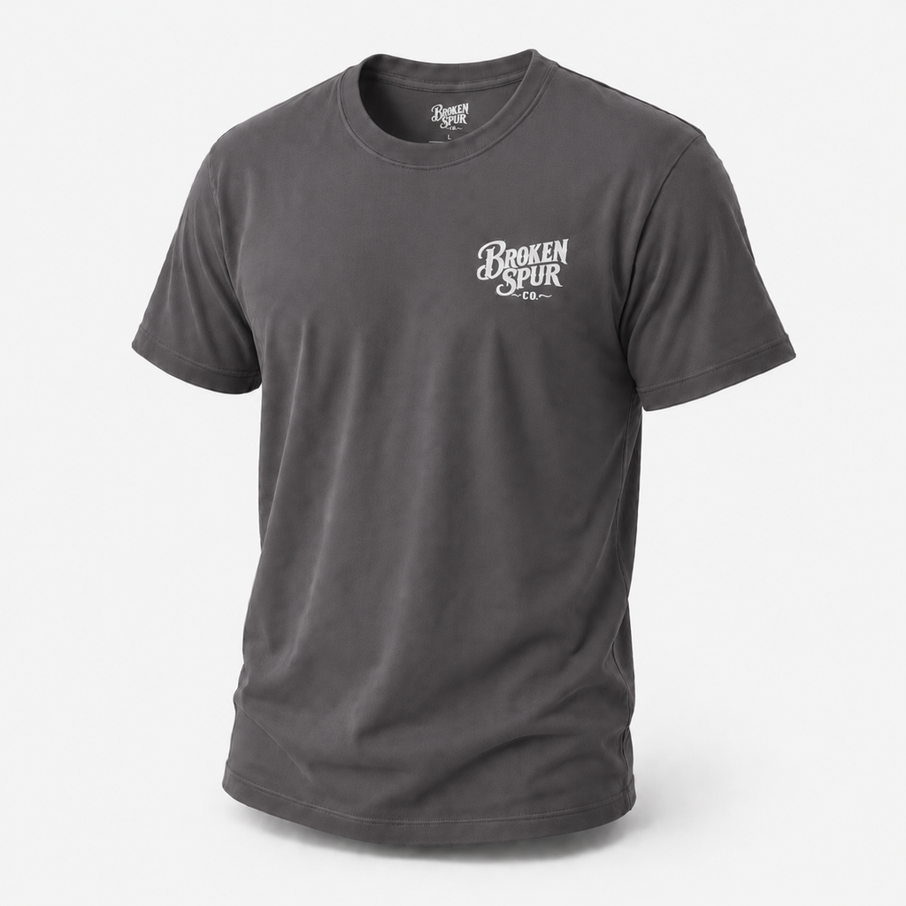 Charcoal The Cavalry Vintage Ranch Truck T-shirt, front view featuring an old ranch truck racing down a dirt road with dogs i