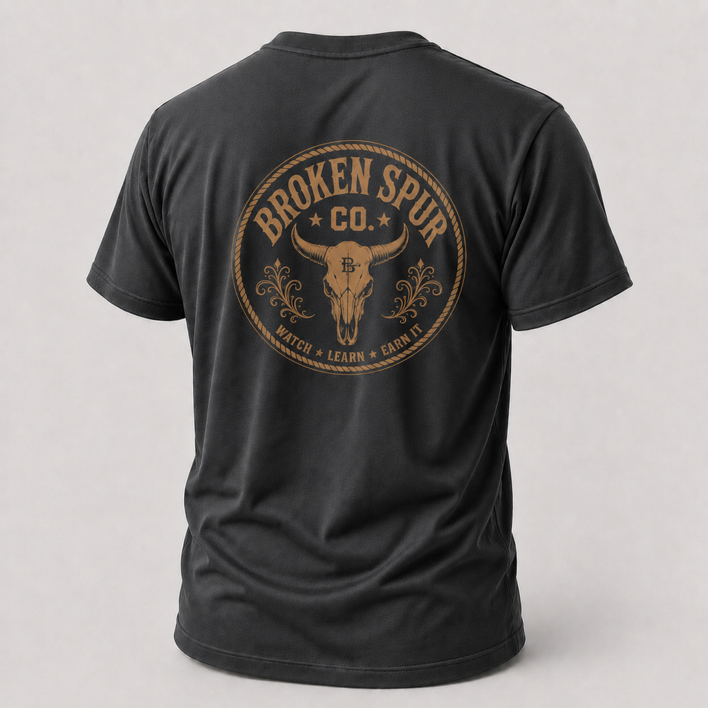 Dark Heather Gray Earn It Western Skull T-shirt, back view featuring a weathered Western skull badge and Watch Learn Earn It