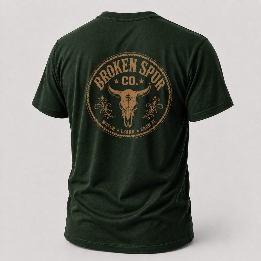 Forest Green Earn It Western Skull T-shirt, back view featuring a weathered Western skull badge and Watch Learn Earn It messa