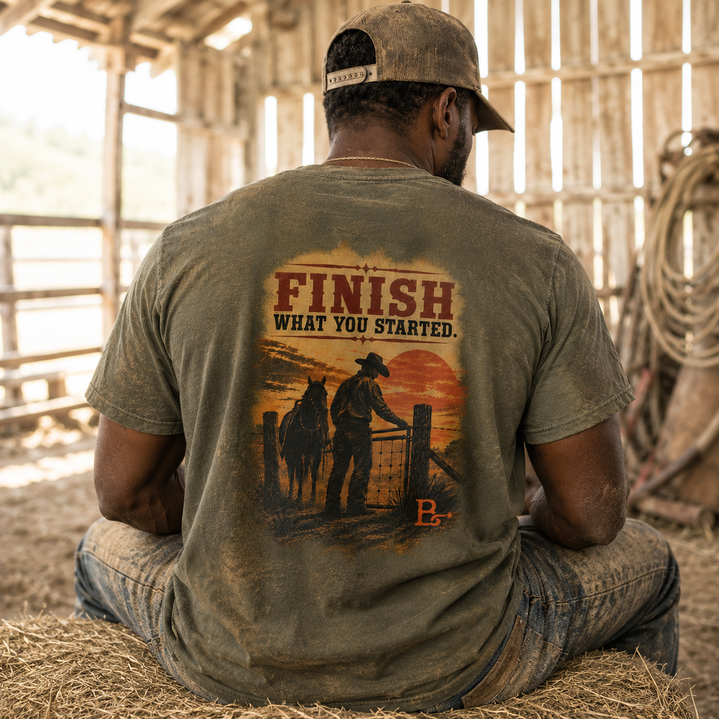 Lifestyle view of The Last Gate Ranching T-shirt featuring a cowboy closing the final ranch gate at dusk