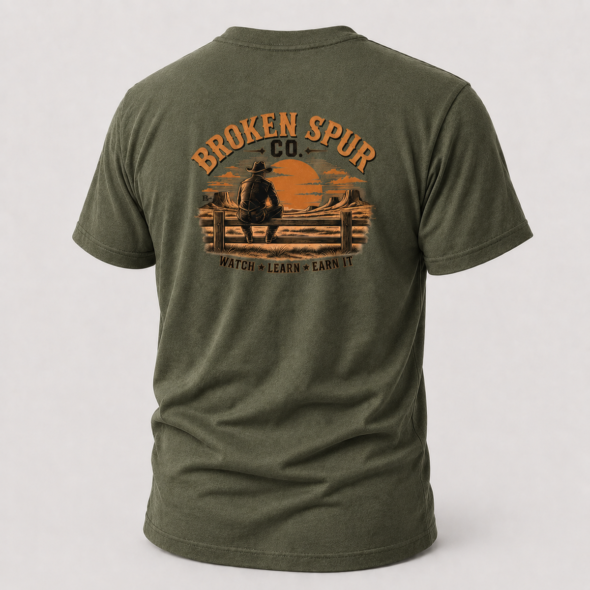 Military Green The Fence Ranch Hand T-shirt, back view featuring ranch hands learning the work along a fence line